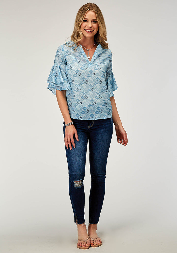 WOMENS SHORT SLEEVE PULLOVER IKAT CHEVERON PRINT POLY BLOUSE WITH V NECK PLACKET AND CIRCULAR RUFFLE CUFFS